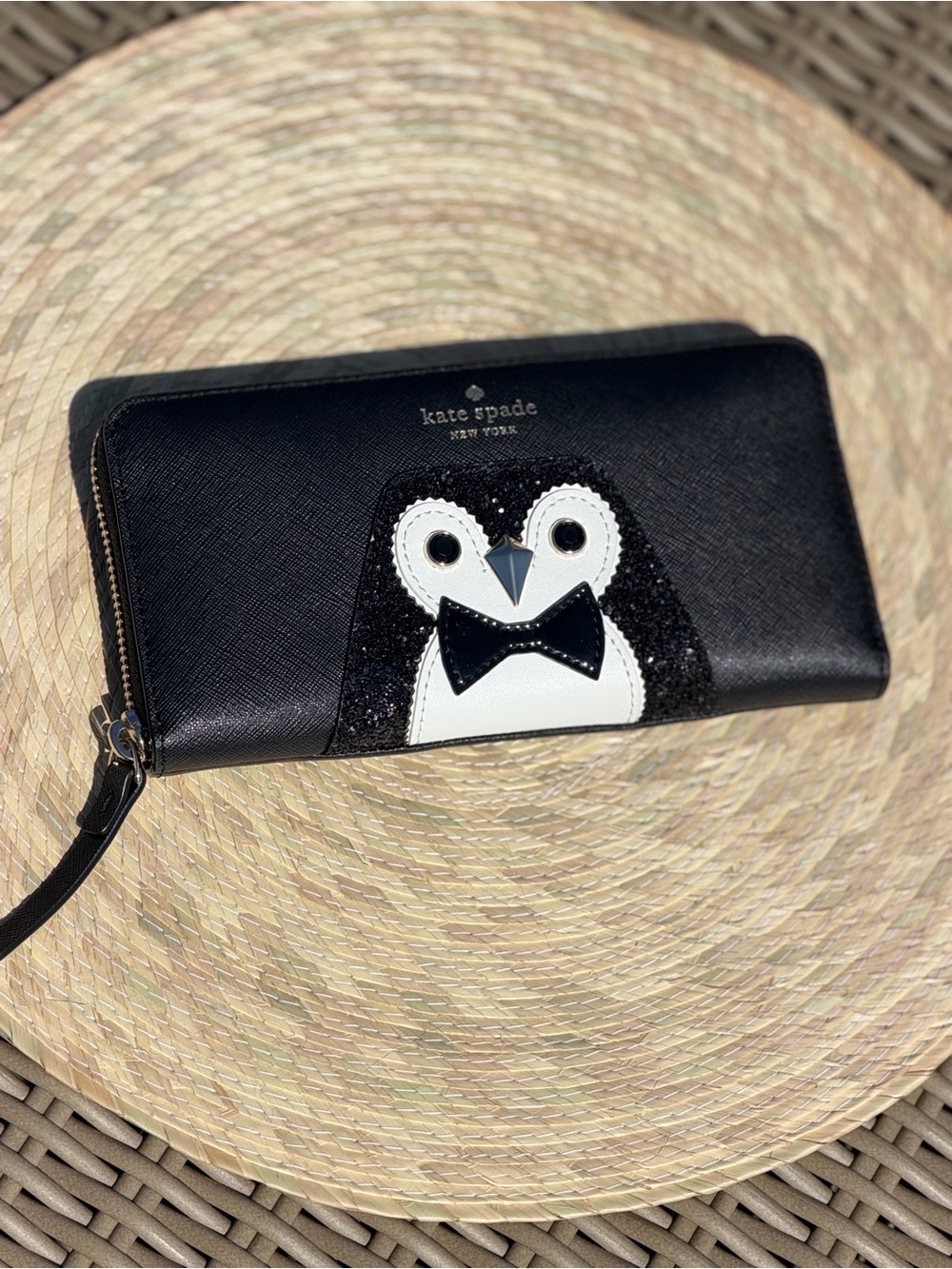 kate spade black zip-around wallet with penguin appliqué
